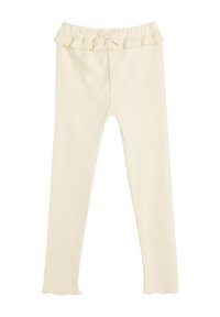 Leggings color crema con un elastico arricciato in vita e un piccolo dettaglio a fiocco. Il tessuto è morbido, a coste e elasticizzato, offrendo comfort e flessibilità.