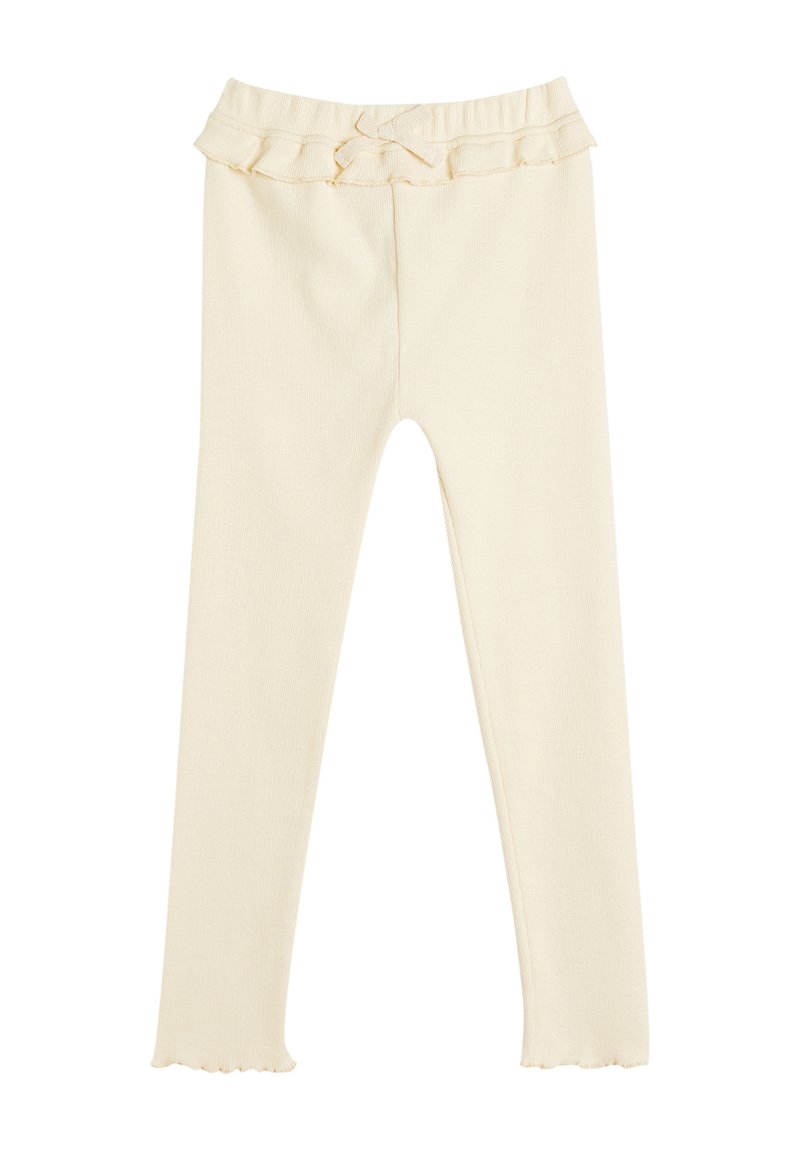 Leggings color crema con un elastico arricciato in vita e un piccolo dettaglio a fiocco. Il tessuto è morbido, a coste e elasticizzato, offrendo comfort e flessibilità.