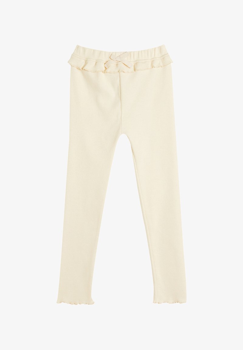 Leggings color crema con un elastico arricciato in vita e un piccolo dettaglio a fiocco. Il tessuto è morbido, a coste e elasticizzato, offrendo comfort e flessibilità.