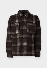 Veste en polaire à carreaux bruns avec un devant à boutons, un col évasé et une poche poitrine ; elle présente un tissu texturé et moelleux.