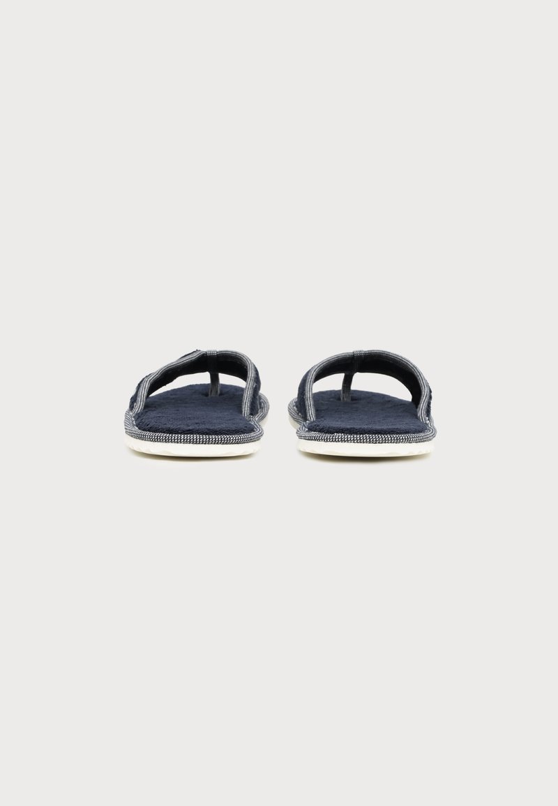 Pair of navy blue fabric flip-flop sandals with white soles, viewed from the front on a plain light background.