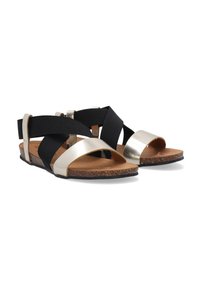 Zwarte en gouden sandalen met een kurken zool. Bevat gekruiste zwarte elastische banden en een metallic gouden band over de tenen.