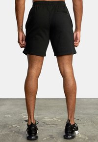 Black cotton blend shorts with an elastic waistband, side pockets, and a rear zipper pocket, featuring a relaxed fit and smooth texture.