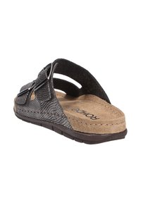 Black textured slide sandal with sandy beige footbed, two adjustable straps with metal buckles, and a flexible rubber sole.