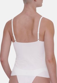 White camisole with thin adjustable straps, smooth texture, and a fitted design. The back features a simple, seamless cut.