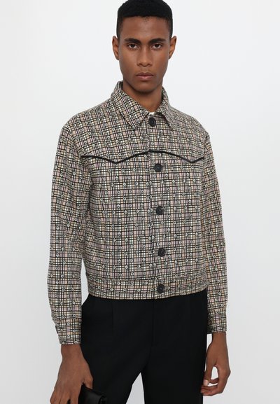 Checked jacket with a blend of beige, black, and white. Features black buttons, a collar, and a cropped design. Soft fabric with a structured fit.