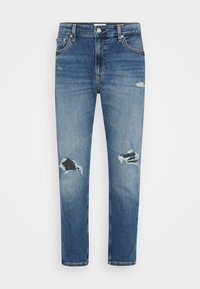 Ljust blå denimjeans med rak passform, med två stora revor vid knäna och en lätt urtvättad finish. Femfickorsdesign, dragkedja.