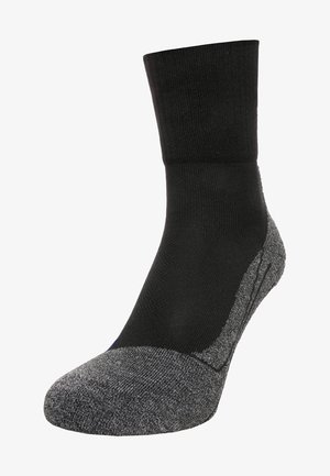 Schwarze Socke mit geripptem oberen Teil und verstärktem grauem Zehen- und Fersenbereich. Hergestellt aus einer Materialmischung, die eine strukturierte Oberfläche und Strapazierfähigkeit bietet.