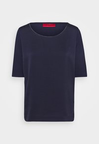 Haut bleu marine à manches courtes avec un décolleté arrondi et une texture lisse. Présente une étiquette de marque rouge à l'arrière. Design simple et minimaliste.