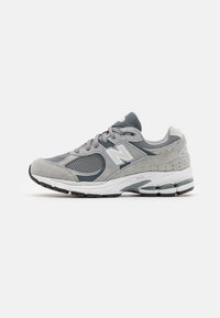 Light gray athletic shoe with a mesh and suede upper, white accents, cushioned sole, and a rounded toe design.