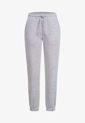 Sive trenerke od meke tkanine, s elastičnim pojasom sa vrpcom, suženim manžetama i otiskom logotipa na lijevoj nozi.