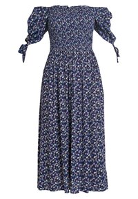 Maxikjol i mörk marinblå tyg, med små blommönster i blått och vitt, smockad midja och puffärmar med bandaccenter.