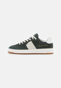 Green suede sneaker with white mesh and leather accents. Features cream laces, a gum rubber sole, and embossed logo detail. Side view.