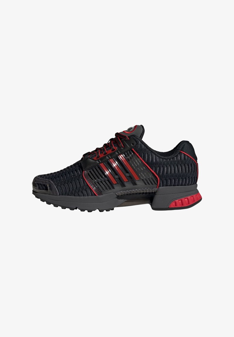 Black and red athletic shoes with a mesh upper, reflective accents, and rubber outsole. Features a padded collar and lace-up design.