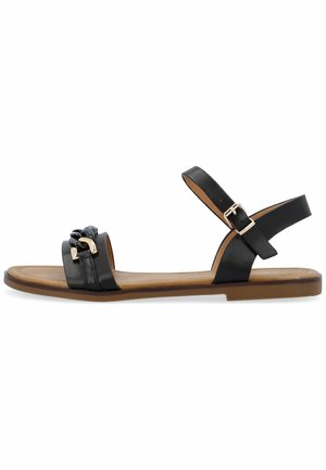 Mustat nahka sandaalit, jossa litteä pohja, kaksoishihnasuunnittelu, kultasävytteiset yksityiskohdat ja säädettävä nilkkasolki. Sileä pinta ja minimalistinen tyyli.