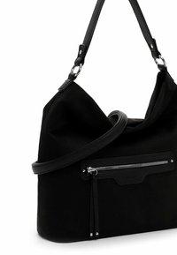 Black fabric shoulder bag with a slouchy design, featuring a textured leather strap and a front zip pocket with a tassel detail.