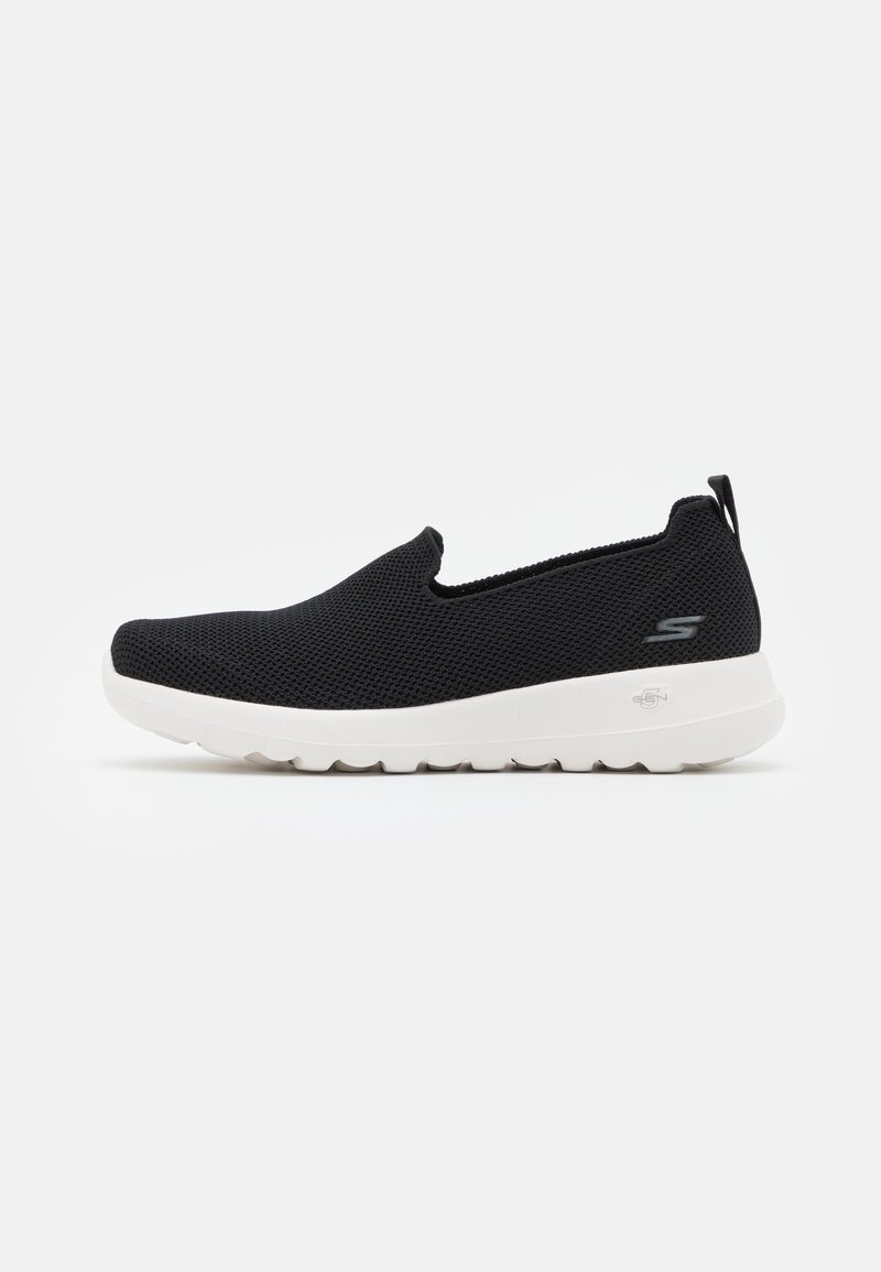 Black slip-on shoes with a breathable mesh upper, white outsole, and textured detail on the sole. Logo accent on the side.