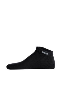 Calcetín negro de tobillo hecho de una tela suave. Presenta un puño acanalado con un sutil logo "BOSS" en gris. Forma elegante y contorneada para un ajuste ceñido.