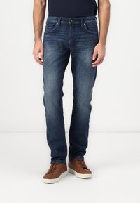 Dark blue denim jeans with a straight-leg cut, featuring front and back pockets, subtle fading, and a button-fly closure.