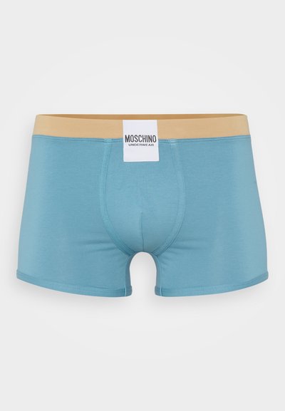 Light blue boxer briefs made of smooth fabric with a beige elastic waistband. Features a white label with "MOSCHINO UNDERWEAR" branding.