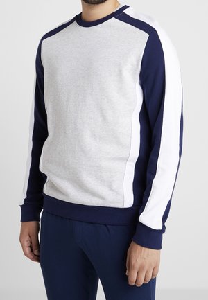 Grå och marinblå sweatshirt med vita sidostråk, ribbad rund halsringning och muddar, mjuk textur, med en avslappnad passform och utan synliga logotyper.