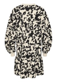 Robe à manches longues avec imprimé animalier abstrait noir et blanc, poignets ajustés et ourlet de jupe froncé.