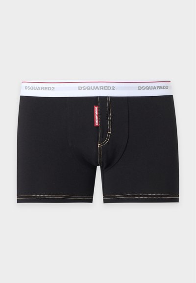 Boxers noirs pour hommes avec ceinture élastique blanche portant la marque DSQUARED2 et coutures contrastantes le long des bords et de la braguette.