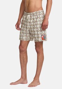 Men's swim shorts feature a cream background with a colorful palm and wave pattern. Elastic waistband, drawstring, and side pocket visible.