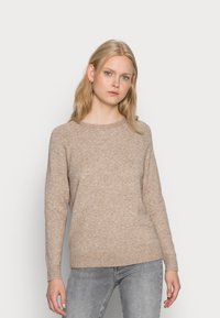 Beige strikkegenser med rund hals, ribbestrikkede mansjetter og kant, med en myk tekstur og en avslappet passform.