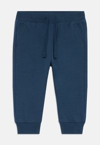Blaue Baumwoll-Jogginghosen mit elastischem Bund und Kordelzug, zwei Seitentaschen und gerippten Bündchen. Glatte Textur mit einem schlichten Design.