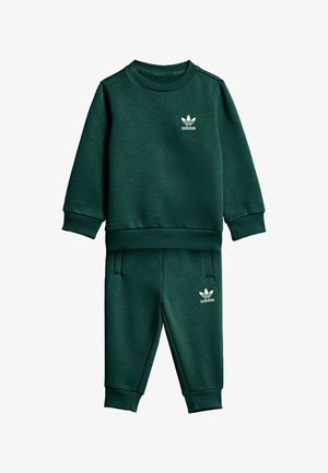 Completo felpa e pantaloni verdi realizzato in tessuto morbido, con polsini e girovita a coste. Logo Adidas bianco sul petto e sul lato.