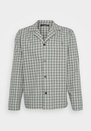 Veste à carreaux verts et blancs avec revers cranté, manches longues et boutons noirs, featuring un logo discret sur la poitrine.