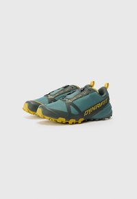 Trail running shoes in teal and yellow with a textured upper, sturdy sole, and pronounced lugs for traction. Features pull tabs and sleek design.