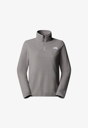 Harmaa fleece-paita, jossa on puolivetoketjukaulus, pitkät hihat ja pieni valkoinen logo rinnassa. Pehmeä rakenne ja rento istuvuus.