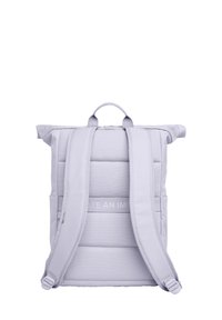 Rull-top reppu vaaleanlilassa kankaassa, jossa on pehmustettu selkä ja säädettävät olkahihnat. Varustettu ylhäältä tarttumiskahvalla ja sivutaskuilla. Sileä pinta.