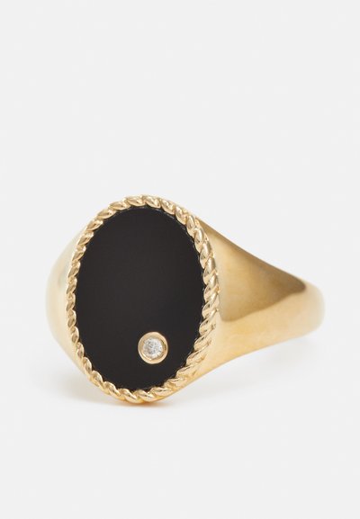 Gold ring featuring a black oval stone, embellished with a small diamond and a twisted rope pattern around the stone's edge.