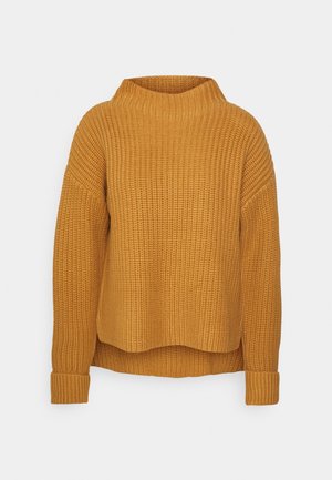 Pull en maille jaune moutarde avec un col montant, une texture côtelée, des épaules tombantes et une coupe ample. Manches avec poignets et un ourlet court.