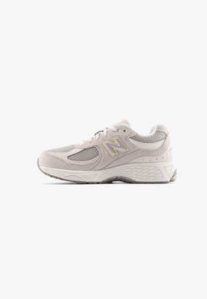 Scarpe da corsa grigie e beige realizzate in materiali mesh e suede, con colletto imbottito, design con lacci, suola testurizzata e dettagli riflettenti.