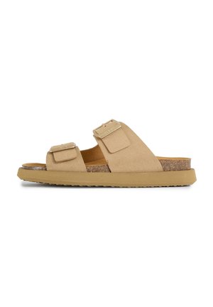 Beige suede sandal with two adjustable straps and gold-tone buckles, cork footbed, and flat rubber sole.