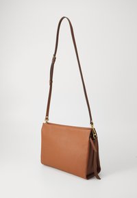 Brown leather shoulder bag with a structured shape, adjustable strap, and gold-tone hardware accents. Textured surface adds detail.