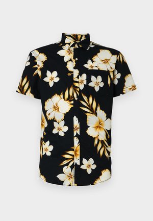 Chemise à manches courtes, noire, avec de grands motifs floraux blancs et dorés, un col classique et une poche sur la poitrine gauche.