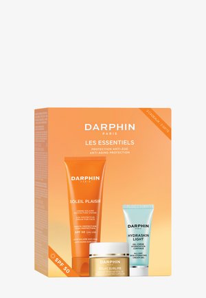Coffret anti-âge Darphin Les Essentiels avec crème solaire visage SPF 50, capsules boostant l'éclat et gel-crème hydratant.