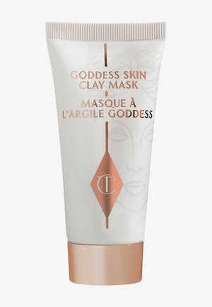 Tube blanche avec un capuchon en rose doré métallique. Présente un texte d'étiquette en noir et rose doré, représentant un design de visage minimaliste.