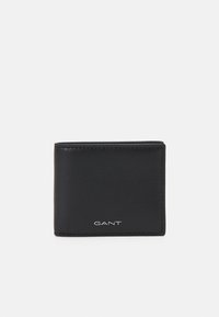 Black leather wallet with a smooth texture, bi-fold design, subtle stitching, and GANT logo in silver at the bottom front.
