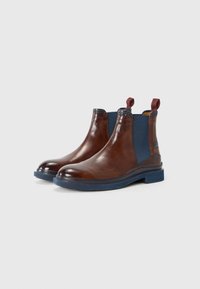 Bottines en cuir marron avec un côté élastique bleu, bout rond et semelle en caoutchouc bleu. Comprend des tirettes pour un enfilage facile.