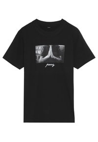 Black cotton t-shirt featuring a frontal graphic of hands in a praying position and the word “pray” in white underneath. Short sleeves.