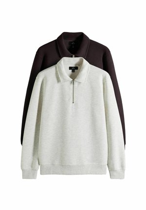To langærmede sweatshirts med lynlås i halsen, den ene lysegrå foran og den anden mørkebrun bagpå, vist på en hvid baggrund.