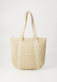 Borsa a tracolla intrecciata in paglia beige, dotata di due ampie maniglie in tessuto e design aperto, con una finitura texturizzata e base arrotondata.