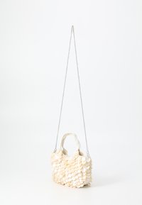 Small handbag, white with a textured surface, featuring circular fabric appliqués. Includes two handles and a silver chain strap.