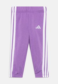 Purple athletic pants with white side stripes, elastic waistband, and Adidas logo. Smooth texture, tapered design for a fitted look.